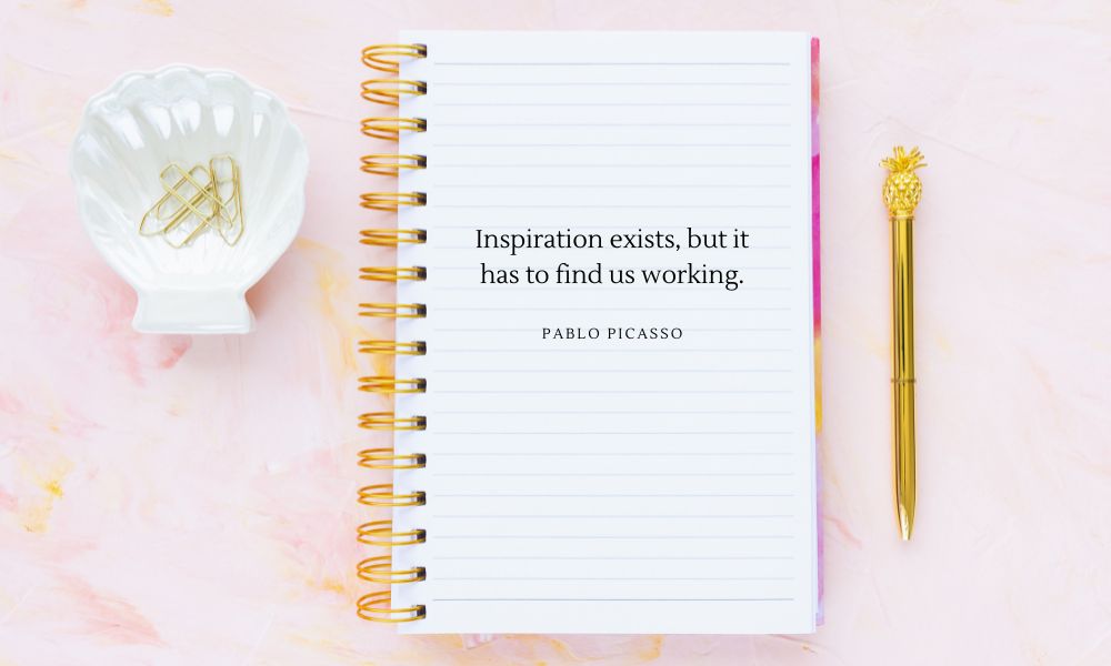 pink table with notebook open and a gold pen and shell bowl filled with paper clips, how to use a writer's notebook