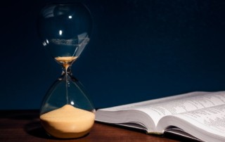 hourglass almost empty next to book, ending your mystery