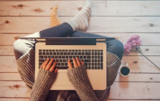 woman sitting on floor typing on a laptop; 9 steps to write a book