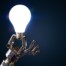 robot hand holding a lightbulb; AI-Powered Writing Assistants