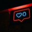 neon sign of Instagram "like" image of heart and 0; A Writer's Guide to Crafting the Perfect Instagram Bio