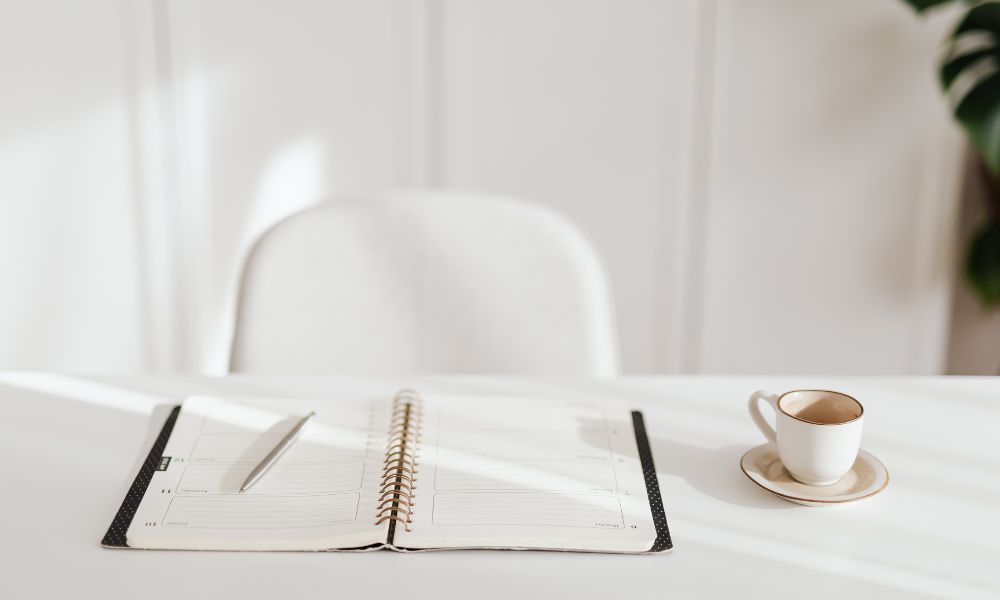 paper planner on a white table; writing planner