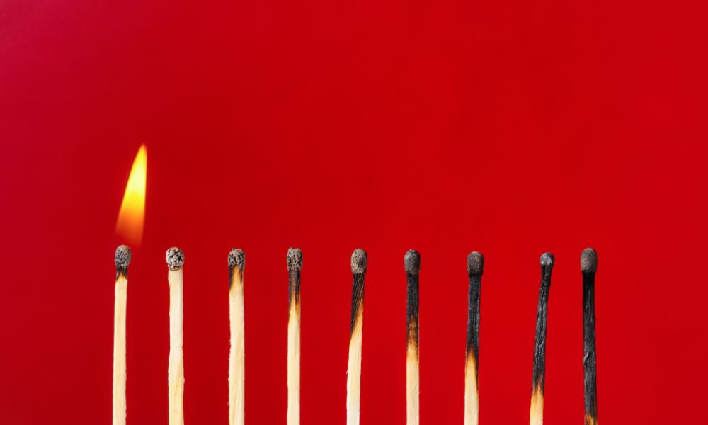 red background with 8 matchsticks all burned down; writing burnout